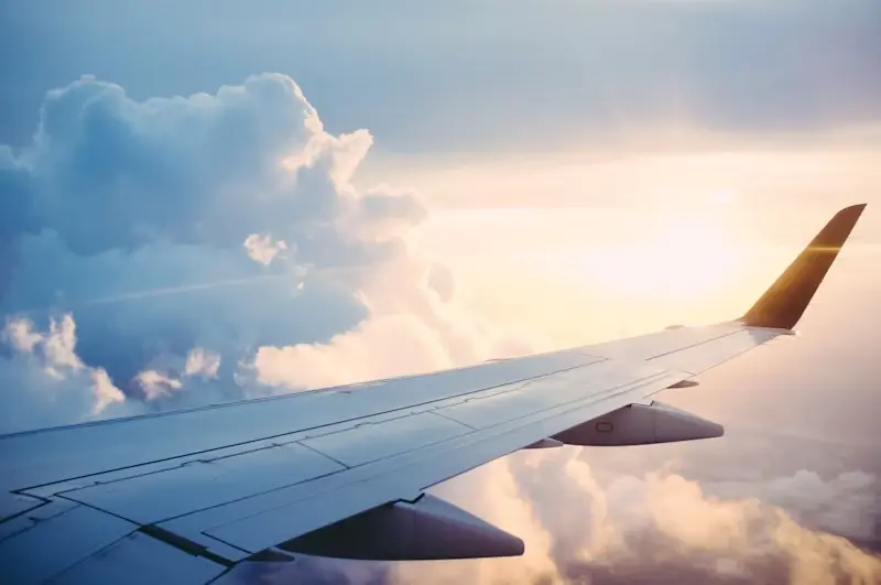 An aeroplane wing above the clouds